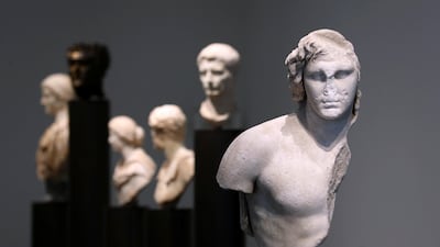 A statue of Alexander the Great frames a colonnade of Roman busts that include several emperors. Chris Whiteoak / The National