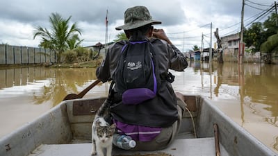 Muhammad Fadzil Wahab, a local volunteer, with a very important passenger. Mohd Rasfan / AFP