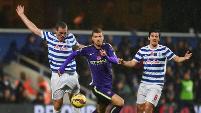 Manchester City's Edin Dzeko chases down the ball against Queens Park Rangers in his side's Premier League 2-2 draw on Saturday. Tom Dulat / Getty Images / November 8, 2014