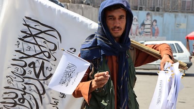 An Afghan man sells Taliban flags in Kabul. EPA