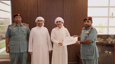 Mohammed Hammad is honoured by Ajman Civil Defence for saving two children from a burning house. Courtesy Ajman Civil Defence