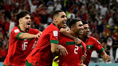 Morocco's Achraf Hakimi celebrates with teammates after scoring the winning penalty. AFP