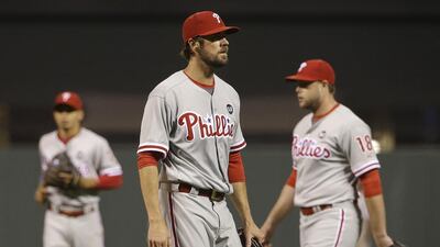 Pitcher Cole Hamels, center, is having a strong year on a woeful team so he could be traded to a title contender very soon. Jeff Chiu / AP Photo