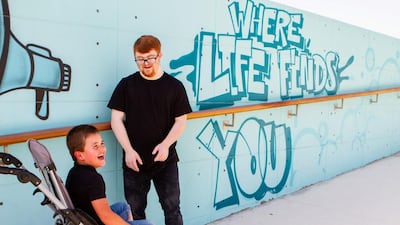 Kieran laughs with Sam. People with disabilities are exempt from wearing masks. Courtesy: Em Ray