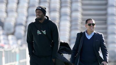 Usain Bolt arrives with manager Ricky Sims for his first training session. Getty Images