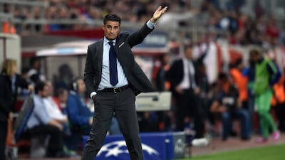 Olympiacos' head coach Michel, whose full name is Jose Miguel Gonzalez Martin del Campo, gestures during the Group A Uefa Champions League match against Juventus at the Karaiskaki stadium in Athens' Piraeus district on October 22, 2014. AFP / ARIS MESSINIS