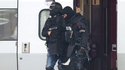 A anti-terrorist unit of the Dutch police carry a man who locked himself in a toilet of a Thalys high-speed train heading for Paris, in Rotterdam central station, Netherlands. Peter Dejong / AP Photo
