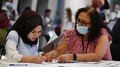 A pupil registers at the London Academy of Excellence in Tottenham to receive her results.