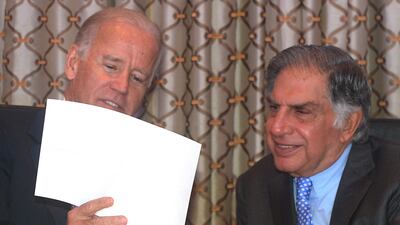 Then-US vice president Joe Biden shows a picture of an Indian Air Force Boeing C-17 Globemaster III transport plane to Mr Tata in 2013. AFP