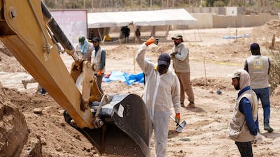 A backhoe being used to uncover the site of a mass grave in Najaf, discovered by chance when property developers began to prepare the land for construction.