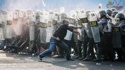 Indonesian police officers block a mock protester during an anti-riot drill as part of security preparations for the upcoming Asian Games 2018 in Jakarta, Indonesia. Mast Irham/EPA