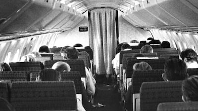 Passengers aboard a Concorde supersonic jetliner flight await lunch as the delta-winged aircraft cruises over the Atlantic Ocean at twice the speed of sound in May 1978. The digital display on the left bulkhead at the front of the cabin shows that the plane has reached Mach 2. AP