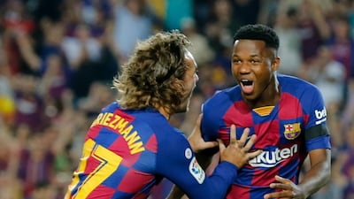 Barcelona´s Guinea-Bissau forward Ansu Fati, right, is congratulated by Barcelona's French forward Antoine Griezmann after scoring the opening goal against Valencia at Camp Nou. Barcelona won the match 5-2. AFP