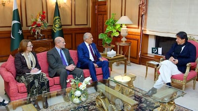 Pakistani Prime Minister Imran Khan (R) speaks with US special envoy Zalmay Khalilzad (3rd L) during a meeting at the Prime Minister's office in Islamabad, Pakistan. Reuters