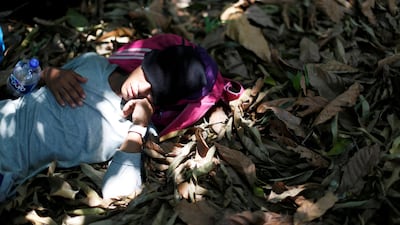 A man belonging to a caravan of migrants from Honduras en route to the United States, sleeps in a forest by a highway in Tuxtla Chico, Mexico. Reuters