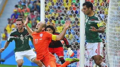 Mexico's Rafael Marquez,right, fouling Arjen Robben of the Netherlands, centre, in the box during the round of 16 at the 2014 World Cup on Sunday. Robben was awarded a penalty on the play. Koen Van Weel / EPA