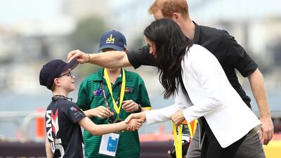 Prince Harry and Meghan give medals to winners of the Young Drivers Challange Getty