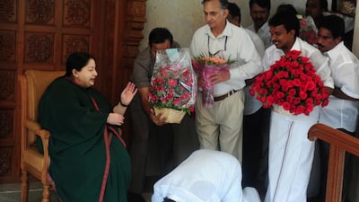 A party cadre prostrates himself at the feet of former chief minister of Tamil Nadu, J Jayalalithaa at her residence in Chennai on May 19, 2016. Arun Sankar/AFP Photo