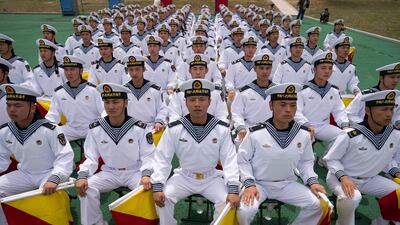 Chinese sailors with signaling flags prepare for the opening of the West Pacific Naval Symposium in Qingdao, Shandong province, China. AP Photo