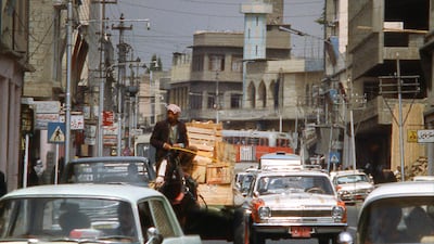 Heavy traffic on a street in downtown Mosul, the largest city in northern Iraq, with the leaning minaret of the Al Nouri Mosque in the background, in 1978. Getty Images