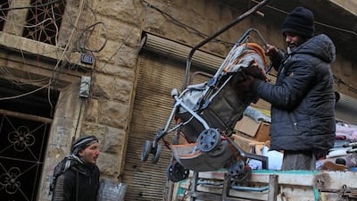 Syrians load their belongings into a truck before driving away from Maaret Al-Numan in the northwestern Idlib province. AFP