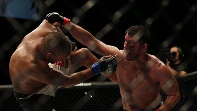 Michael Bisping, right, survived a first round knockdown to win a unanimous points decision against Dan Henderson. Matthew Childs / Reuters
