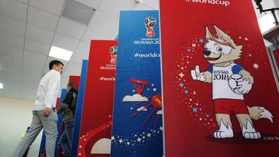 Members of the media get their accreditations for the 2018 FIFA World Cup football tournament in Moscow. Moody's says hosting the World Cup will have limited economic benefit for rated Russian Companies. Kirill Kudryavtsev / AFP