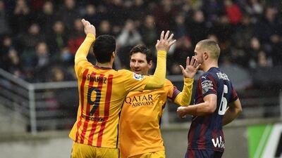 Lionel Messi, centre, celebrates his goal with teammate Luis Suarez. Alvaro Barrientos / AP Photo