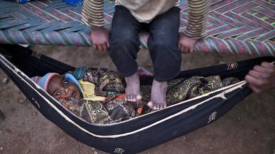 A Pakistani child, lies in a hammock at the site of his mother's work in a brick factory in Mandra, near Rawalpindi, Pakistan. Muhammed Muheisen AP Photo