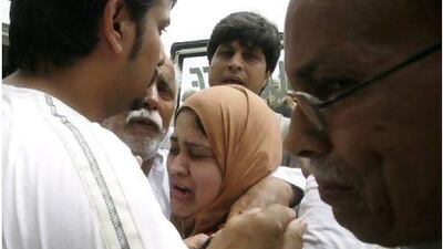 Family members of the murdered Pakistani journalist Syed Saleem Shahzad react after his death, in Karachi yesterday. Fareed Khan / AP Photo
