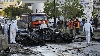 Lebanese army investigators and sappers inspect damages at the scene of a large car bomb explosion that killed five people, including a former government minister. Wael Hamzeh / EPA