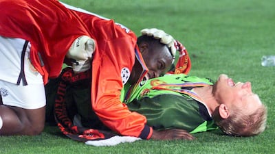 Dwight Yorke, left, and goalkeeper Peter Schmeichel celebrate. AFP