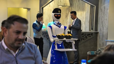 A robot waiter carries an order.