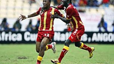 Ghana's Andre Ayew, left, celebrates with teammate Hans Sarpei after scoring the winner against Burkina Faso yesterday.