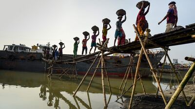 Labourers unload coal from a cargo ship in Gabtoli on the outskirts of Dhaka, Bangladesh. AFP