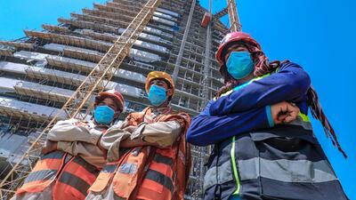 Construction workers take a short break. Victor Besa / The National