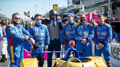 A fan known as the Suited Racer poses with crew members of Andretti Autosport driver Alexander Rossi before the 105th running of the Indianapolis 500. USA TODAY Sports