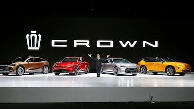 Toyota chief executive Akio Toyoda with vehicles in the latest Crown line-up near Tokyo on Friday. AP