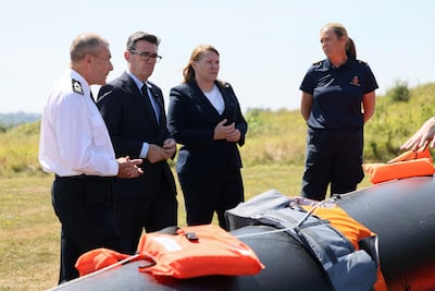 Prime Minister Andy Burnham standing by a migrant boat. Getty Images
