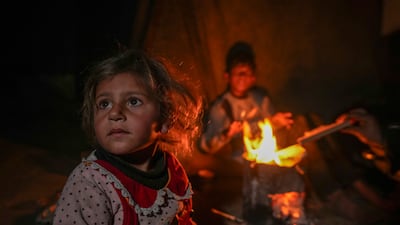 Displaced children in Khan Younis, Gaza on Thursday. Direct deaths caused by Israeli bombardments and gunfire run parallel with the fatalities caused by manmade hunger and disease. AP