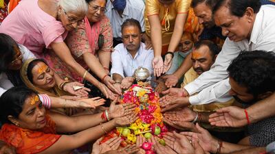 Devotees pay respect to an idol of Krishna during the Janmashtami festival at a temple in Amritsar, India. AFP