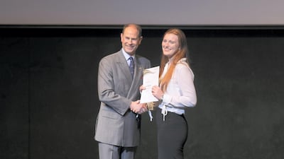 Prince Edward presents awards to students.