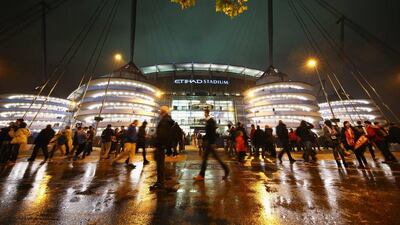 Fans walk outside the Etihad Stadium prior to the Champions League match on Wednesday night between Manchester City and Sevilla. Richard Heathcote / Getty Images