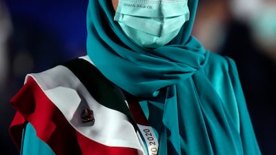 A team member of Iran walks during the opening ceremony in the Olympic Stadium at the 2020 Summer Olympics.