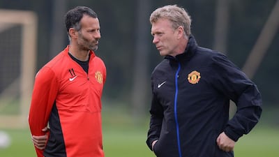 Former Manchester United manager David Moyes, right, speaks to Manchester United's Welsh midfielder Ryan Giggs during a training session at the team's Carrington training complex in Manchester, north-west England on April 22, 2014. Andrew Yates / AFP