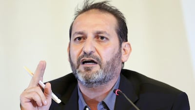 Fateh Hassoun, a member of the Syrian High Negotiations Committee opposition group, addresses the media in Geneva (Pierre Albouy / Reuters)