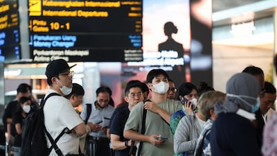 Stranded passengers queue at a customer service area at Soekarno-Hatta International Airport after the airport closed due to the eruption . Reuters
