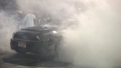 A Mustang lights up its tyres at Yas Marina Circuit. Khushnum Bhandari / The National)