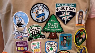 FILE - In this June 18, 2018, file photo, patches cover the back of a Girl Scout's vest at a demonstration of some of their activities in Seattle. The Girl Scouts of the United States of America filed a trademark infringement lawsuit on Monday, Nov. 5, against the Boy Scouts of America for dropping the word "boy" from its flagship program in an effort to attract girls. (AP Photo/Elaine Thompson, File)