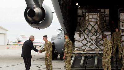 Tom Vilsack, US Agriculture Secretary, greets crew members behind the air shipment, which originated in Zurich, Switzerland. Bloomberg